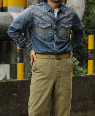 Blue slub denim western shirt worn, front view with snap buttons and chest pockets.