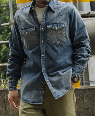 Blue slub denim western shirt worn, front view with chest pockets and snap placket.