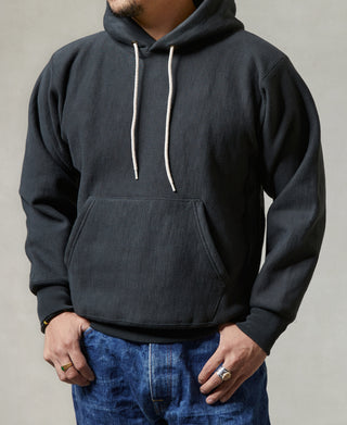 Black pullover hoodie with kangaroo pocket and white drawstrings