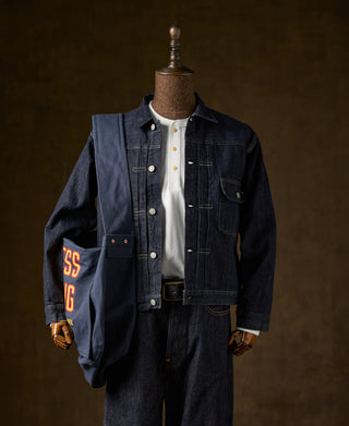 Indigo denim blanket-lined jacket on dress form with front button closure and pockets