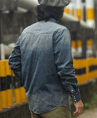 Blue slub denim western shirt worn, back view with yoke seam detail.