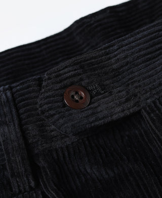 Close-up of black corduroy waistband button and textured wale stripes