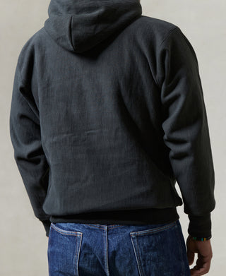 Black pullover hoodie showing back hood and sleeve seam