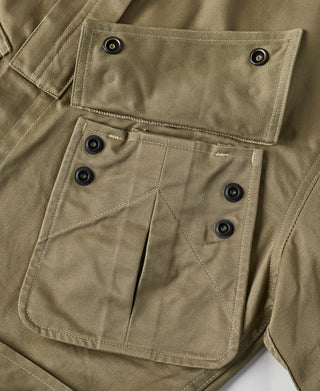 Khaki green jacket with flap chest pockets and black snap buttons