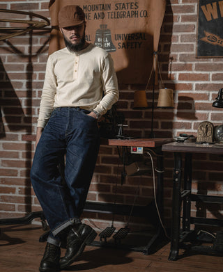 Apricot long-sleeve henley shirt with 3-button placket and ribbed collar, worn