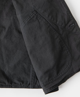 Dark green canvas vest side patch pocket with curved opening and stitched edge