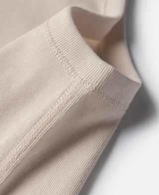 Cotton tank top sleeve seam in light cream with visible stitched detail