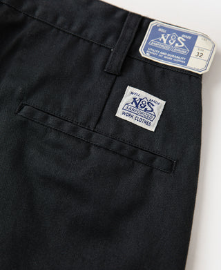 Black work pants with sewn brand tags at waistband and back yoke seam