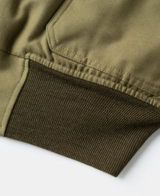 Khaki flight jacket ribbed knit cuff and hem at the lower sleeve.