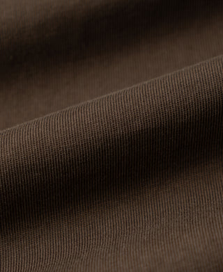 Coffee-brown henley shirt fabric texture close-up, fine knit weave
