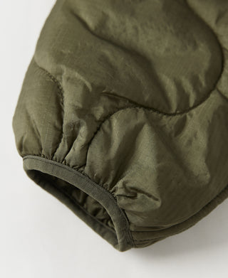 Olive quilted jacket sleeve hem with elastic cuff and padded seam detail