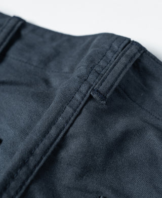 Navy shorts waistband close-up with belt loop and stitched drawstring channel