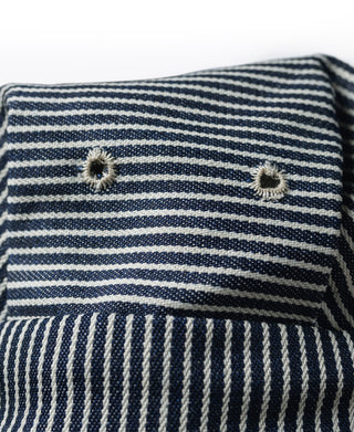 Striped railroad engineer cap close-up of striped crown with star-like button studs