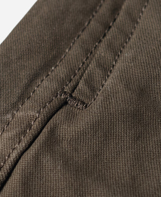 Brown combat pants fly seam with stitched bar-tack detail and textured fabric