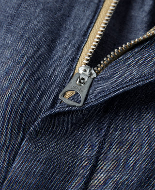 Indigo chambray pants zipper fly detail with metal pull and stitched edge