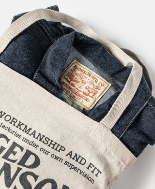 Natural linen tote bag open top showing dark interior lining and branded label.