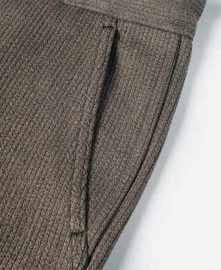 Brown striped pants front with belt loops and stitched pleat detail