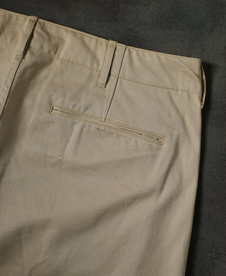 Tan chino trousers with front zip fly, belt loops, and coin pocket