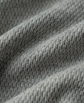Gray waffle thermal knit fabric texture close-up