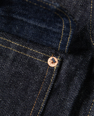 Indigo denim placket button with round metal shank and contrast seam stitching