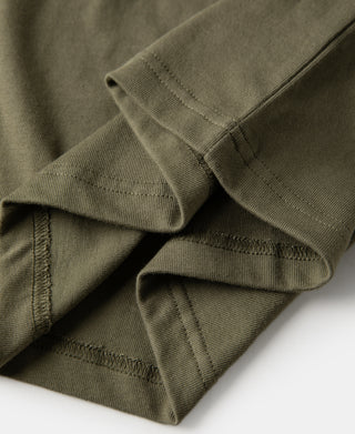 Olive henley t-shirt hem and sleeve cuff overlap with stitching detail