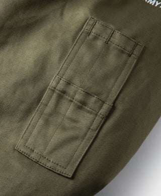 Olive flight jacket sleeve patch pocket with stitched fabric panel