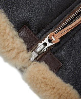 Dark brown leather flight jacket with tan shearling trim and front zipper close-up