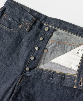 Dark blue denim jeans with buttoned waistband and light gray inner facing