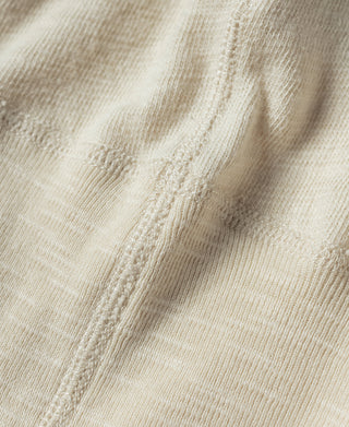 Beige seam and stitching close-up on henley T-shirt