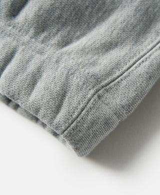 Gray terry cloth sweatpants cuff with ribbed knit trim and edge stitching.