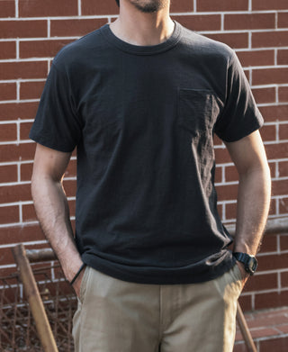 Men's black pocket T-shirt with crew neck worn, short sleeves and pocket visible