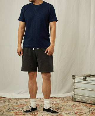 Indigo cotton t-shirt with crew neck and short sleeves, worn with dark shorts