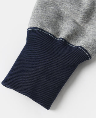 Two-tone hooded sweatshirt sleeve cuff with navy knit and heather gray fabric