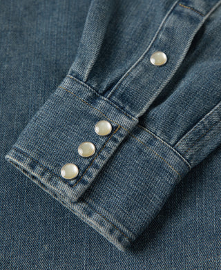 Blue denim western shirt cuff with folded hem and four metal snap buttons