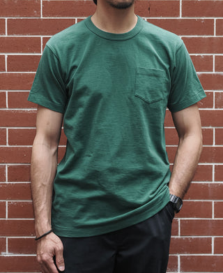 Green crew-neck pocket T-shirt with short sleeves on model