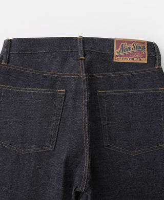 Indigo selvedge denim jeans back view with two rear pockets and "Non Stock" label