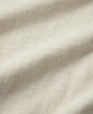 Cream knit T-shirt fabric texture close-up