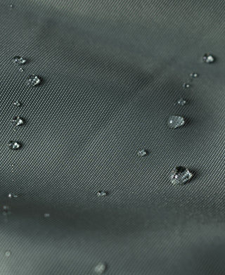 Olive nylon fabric surface with visible water droplets