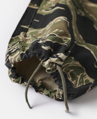 Tiger stripe camo fatigue pants hem with drawstring and gathered cuff.