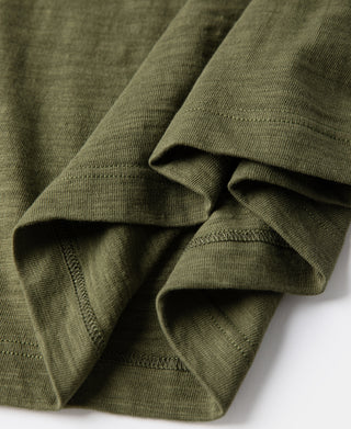 Green cotton t-shirt sleeve and cuff fold detail with stitched hem