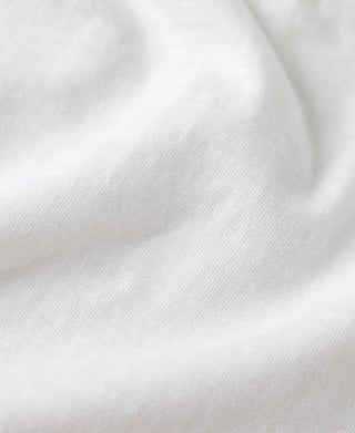 White slub cotton T-shirt fabric close-up, subtle texture
