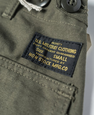Olive utility shorts close-up of interior label reading “SIZE SMALL”
