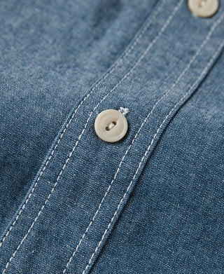 Blue chambray work shirt front placket with round button closure