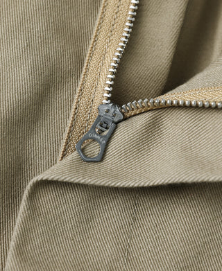 Khaki work pants zipper fly detail with metal pull and close-up stitching