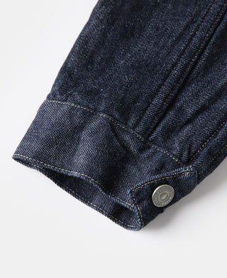Indigo denim jacket cuff with single metal button and contrast yellow seam stitching