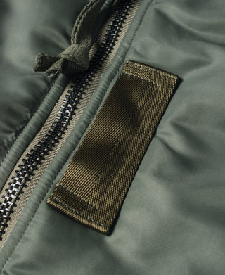 Olive MA-1 flight jacket, front zipper with textured pull tab and fabric tab