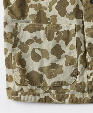 Camo jacket front close-up with large flap pocket and top snap.