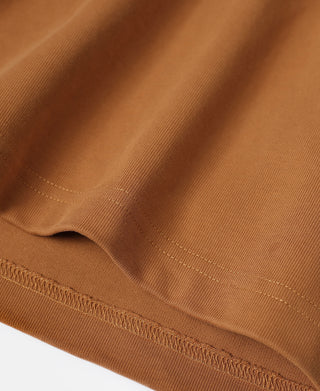 Close-up of orange knit fabric and hem stitching on quarter-zip long-sleeve T-shirt