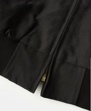 Black bomber jacket hem with ribbed trim and zipper placket detail at side