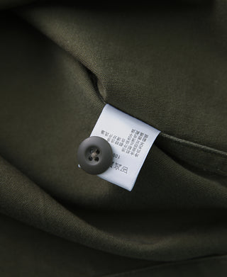 Olive fatigue utility shirt interior neck tag with dark button